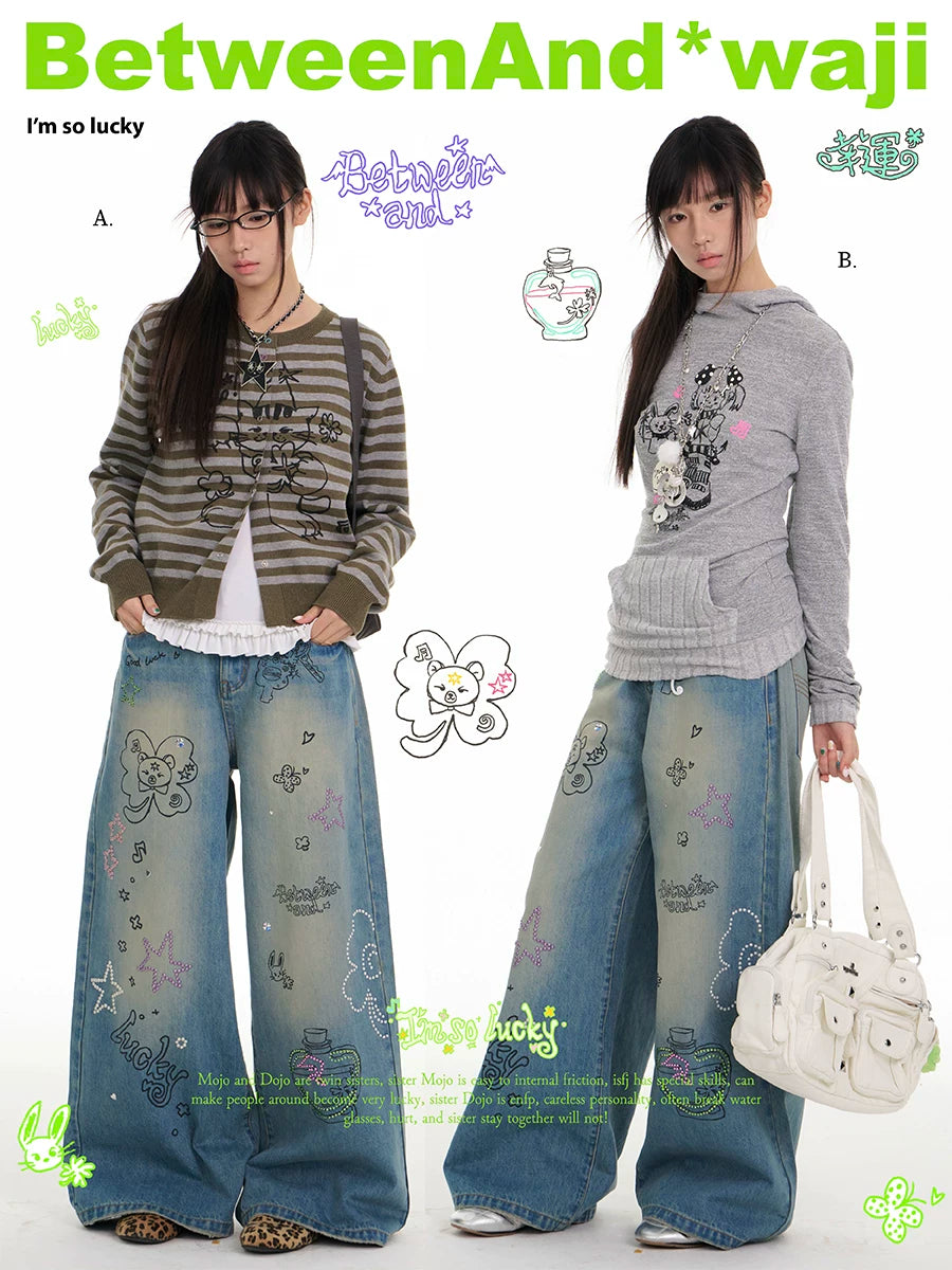 Blue graffiti print jeans with rhinestone details and washed finish