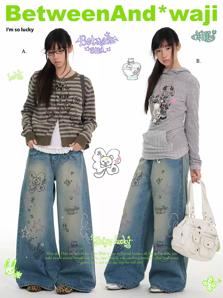 Blue graffiti print jeans with rhinestone details and washed finish