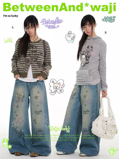 Blue graffiti print jeans with rhinestone details and washed finish
