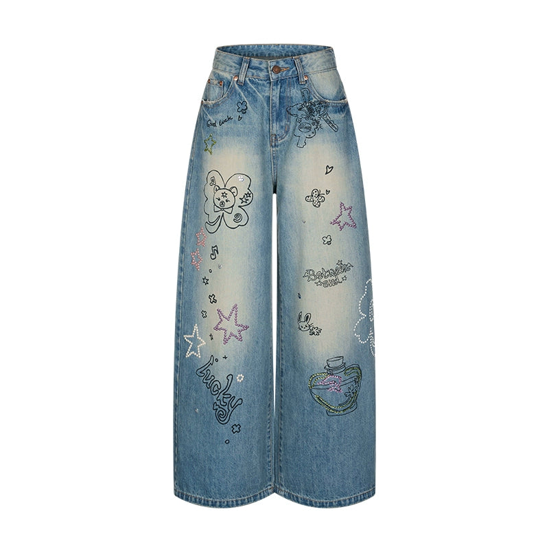 Blue graffiti print jeans with rhinestone details and washed finish