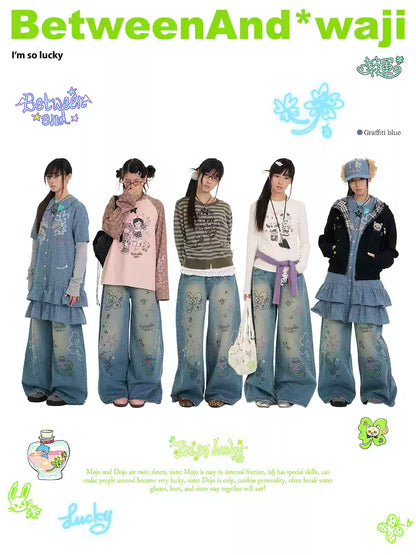 Blue graffiti print jeans with rhinestone details and washed finish