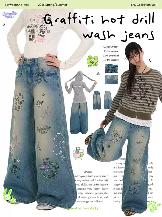 Blue graffiti print jeans with rhinestone details and washed finish
